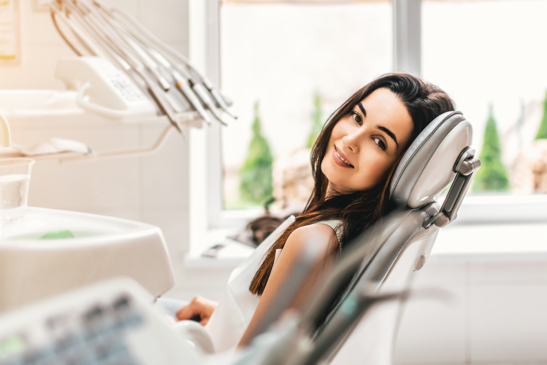 A relaxed woman sitting in a dental chair at Luf Dental, enjoying a stress-free periodontal care treatment for healthier gums and a brighter smile.