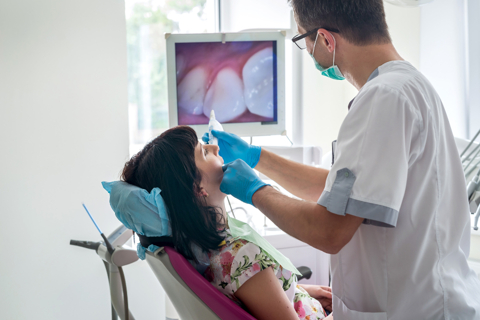 Dentist examining a dental X-ray for accurate diagnosis and treatment planning.